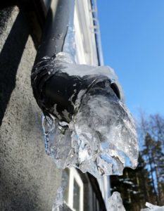 Icicle forming on a downspout, illustrating winter maintenance concerns for homeowners in Holmdel, NC.