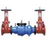Industrial valve apparatus with large red and blue valves used in backflow prevention by Force Plumbing and Heating LLC.