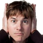 Man with distressed expression covering ears, related to plumbing issues from Force Plumbing and Heating LLC.