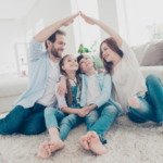 Family of four sitting on a carpet in a well-lit room, highlighting togetherness while discussing plumbing service options.
