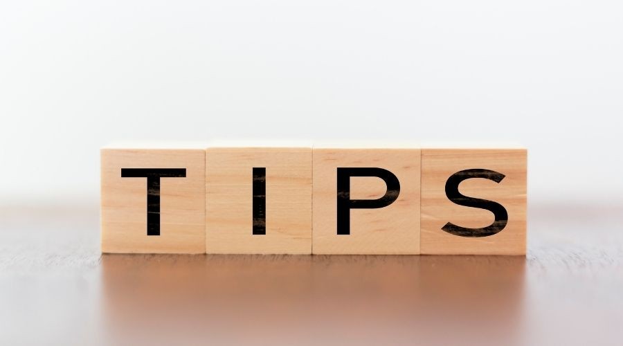 Wooden blocks spelling "TIPS" for plumbing advice by Force Plumbing and Heating LLC, against a light background.