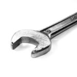 Shiny metal adjustable wrench showcasing open-ended design and adjustable jaw for plumbing maintenance tasks.