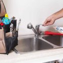 Kitchen sink in use with tools nearby; Force Plumbing and Heating LLC service-focused home maintenance.